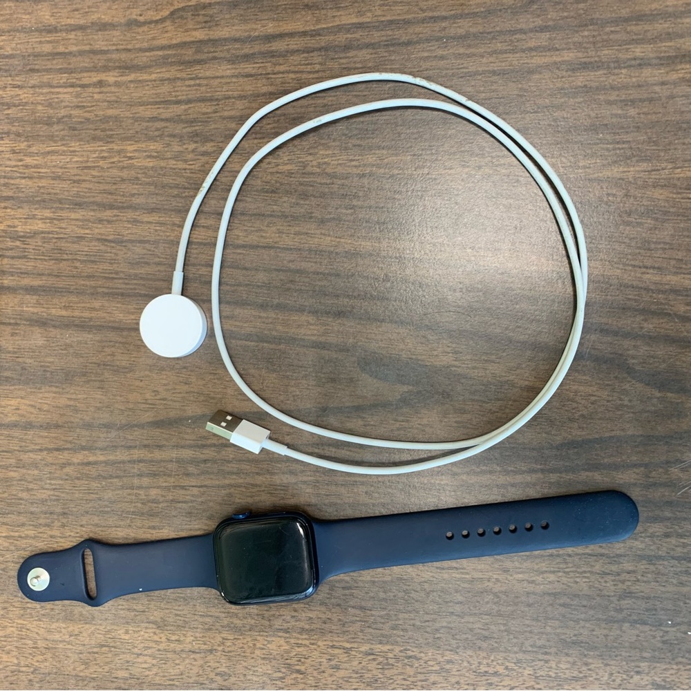 Apple Smartwatch with Black Band and White Charger